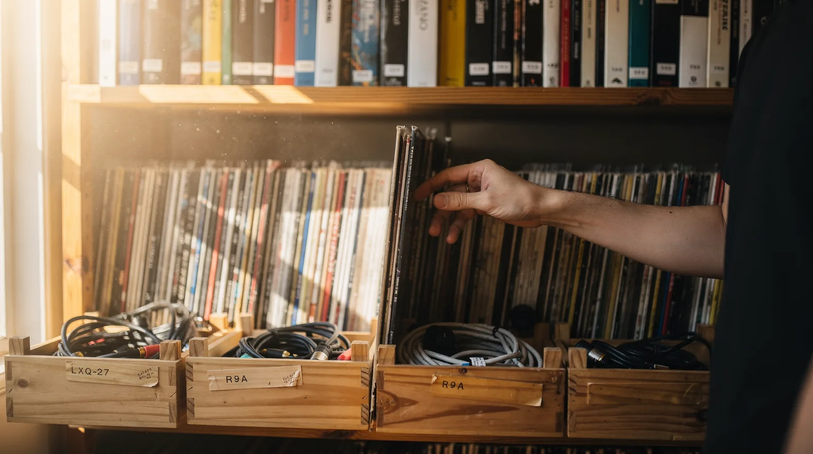 Shelves of records and labelled crates in daylight